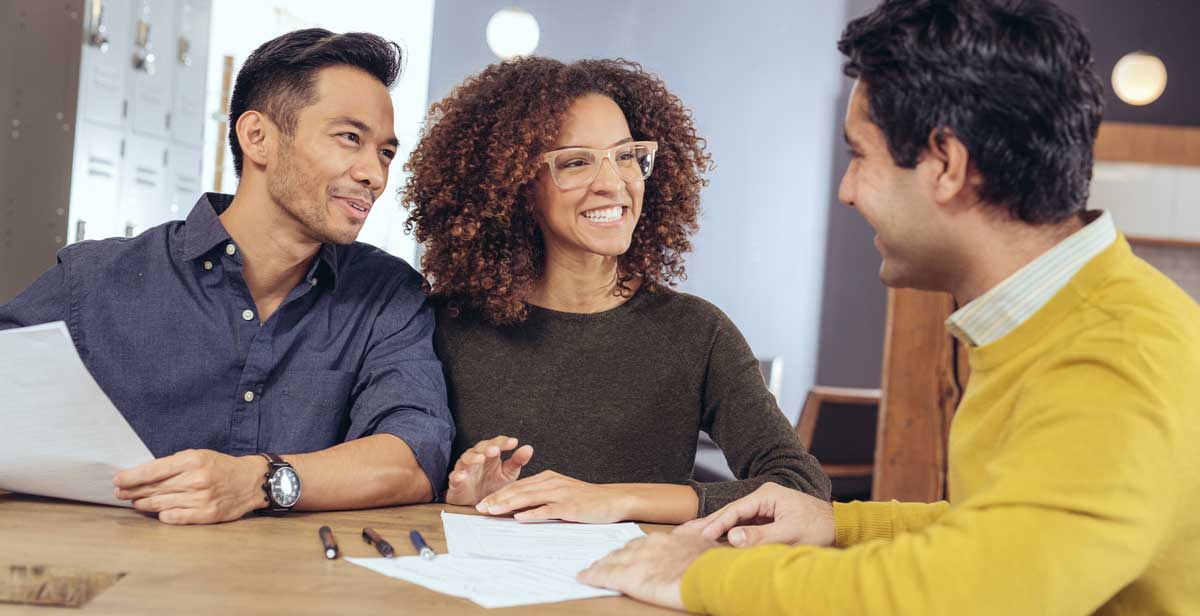 man talking to two clients